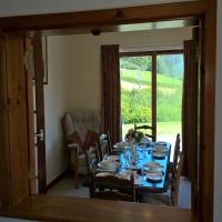 Dining room with dual aspect views down the Welsh valley.